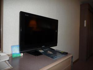 a flat screen tv sitting on top of a desk at Tokyo Grand Hotel in Tokyo