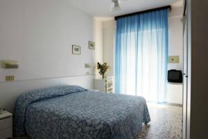 A bed or beds in a room at Hotel Irene