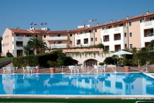 a large swimming pool in front of a building at Heraclea Hotel Residence in Policoro