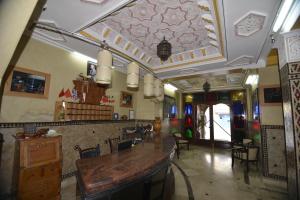 a restaurant with a table and chairs in a room at Essaouira Wind Palace in Essaouira