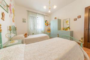 トッレ・サン・ジョヴァンニ・ウジェントにあるVilla Michelaのベッドルーム1室(ベッド2台、ドレッサー付)