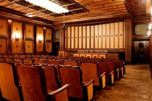 an empty auditorium with brown chairs in a building at Дом Писателей Цахкадзора in Tsaghkadzor