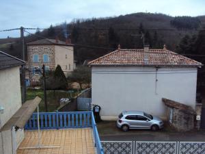 a car parked in a parking lot next to a garage at Maison LES BLEUETS in Le Perréon +4 photos