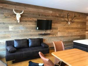 a living room with a couch and a table at Bergblick Walchsee in Walchsee