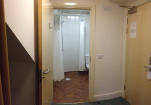 a hallway with a door leading to a bathroom at Louisa Lodge & Purbeck House Hotel in Swanage