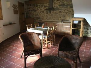 a kitchen with a table and chairs in a room at Casa rural La Sabina in Fortanete