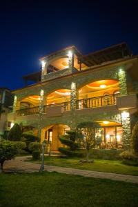 a large building with lights on it at night at Morfeas Guesthouse in Kato Loutraki
