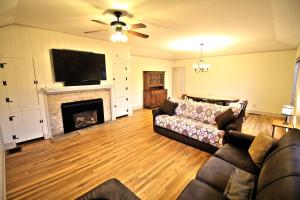 a living room with a couch and a fireplace at Peach Tree Inn & Suites in Fredericksburg