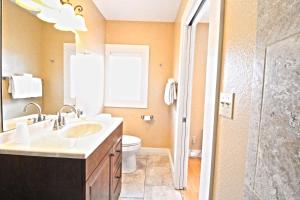a bathroom with a sink and a toilet and a shower at Peach Tree Inn & Suites in Fredericksburg +57 photos