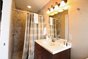 ein Badezimmer mit Waschbecken und Dusche in der Unterkunft Peach Tree Inn & Suites in Fredericksburg