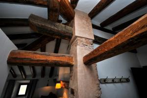 a large wooden cross in a room with wooden beams at La Casa Grande de Albarracín in Albarracín