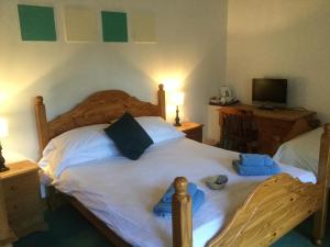 a bedroom with a bed with blue towels on it at The Jolly Huntsman in Chippenham