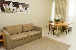 貝洛奧里藏特的住宿－西達德新星伊姆帕爾套房酒店，客厅配有沙发和桌子