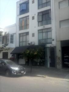 a car parked in front of a building at Departamento Fran in La Plata