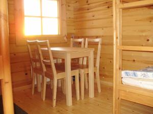 a dining room with a table and chairs in a cabin at Pohjanranta Cottages in Keminmaa