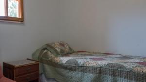 Una cama o camas en una habitación de Hostería Gwesty Plas y Coed