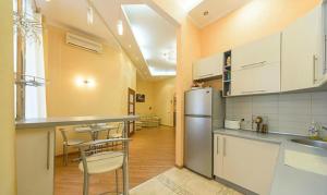 a kitchen with a refrigerator and a table and chairs at квартира in Kyiv