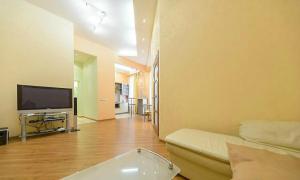 a living room with a couch and a flat screen tv at квартира in Kyiv