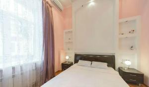 a bedroom with a large bed and a large window at квартира in Kyiv