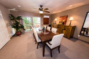 a dining room with a table and white chairs at San Vicente Golf Resort in Ramona