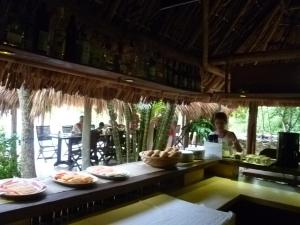 a man standing behind a counter with plates of food at Hacienda Hotel Santo Domingo in Izamal