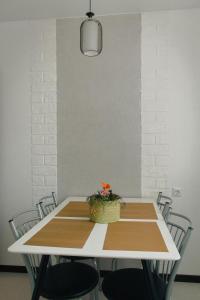 a dining room table with a basket of flowers on it at Sky the Apartment Centre in Tiraspol