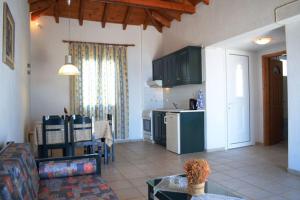 a kitchen and a living room with a couch and a table at Votsalo Apartments in Patitiri +14 photos