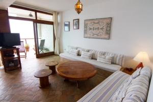 a living room with a couch and a table at Appartement Taghazout in Taghazout