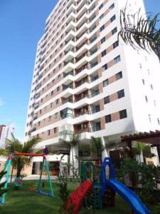 a playground in front of a large building at Flat Futuro Prince Premium in Recife