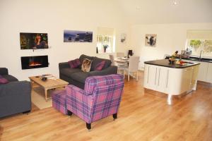 a living room with a couch and a table at Campion Lodge in Chappel