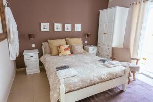 a small bedroom with a bed and a white cabinet at Ghand in-Nanna B&B in Mellieħa