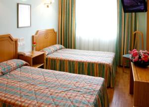 Postel nebo postele na pokoji v ubytování Hotel Río Cabia