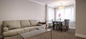 a living room with a couch and a table at Woodcrest Hotel in Santa Clara