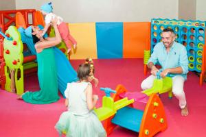 a man and a little girl playing in a playground at Hotel Milano Helvetia - in centro con piscina in Riccione