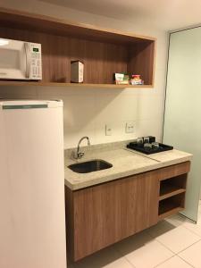 a kitchen with a sink and a microwave at Rio Stay Rio Centro in Rio de Janeiro