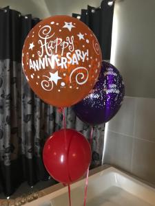 two balloons with a happy anniversary written on them at Spa Suites at RAVEN in Hepburn Springs