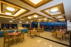 a restaurant with tables and chairs in a room at Mountain Star Hotel in Taunggyi