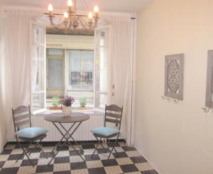 a dining room with a table and chairs and a window at My Little French House in Monflanquin
