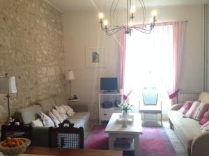 a living room with a couch and a table at My Little French House in Monflanquin