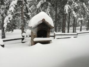 a bird house covered in snow in a park at Holiday Home Jela in Mrkopalj