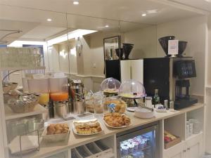 a kitchen with a counter with food on it at Hotel Guerrini in Venice