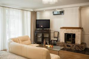 a living room with a couch and a fireplace at VIP Hotel in Izmail