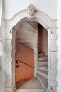 a stone archway with a staircase in a room at Nobile House in Venice