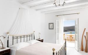 a bedroom with a bed with a view of the ocean at Melian Boutique Hotel & Spa in Pollonia