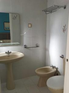 a bathroom with a sink and a toilet and a mirror at Apartamentos Ágata V.v. in La Manga del Mar Menor