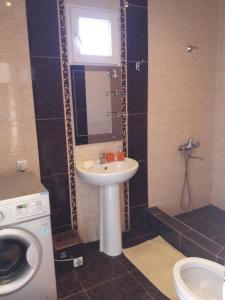 a bathroom with a sink and a washing machine at Betegi Guest House in Mestia