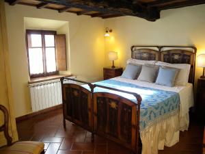 a bedroom with a large bed in a room at Agriturismo Il Gufo in San Marcello Pistoiese