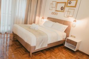 a bedroom with a bed with two towels on it at Jetties & Moorings central apt in Kavála