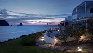 a building with a view of the ocean at night at Melian Boutique Hotel & Spa in Pollonia