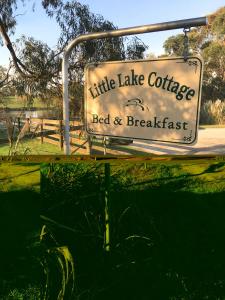 a sign for a little lake coffee bed and breakfast at Little Lake Cottage in Nyora